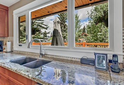 Kitchen sink and windows overlooking back porch